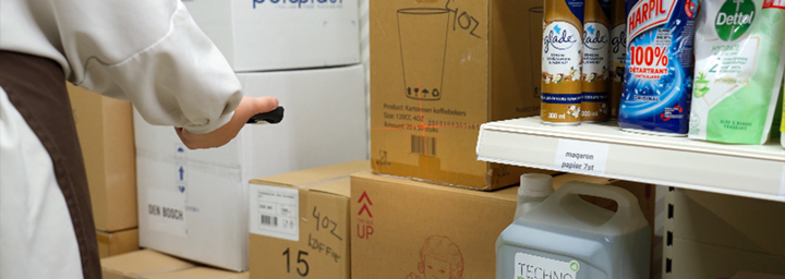 Photograph of the MT93 Megattera Pro Angled Shooter mobile computer scanning barcodes in a retail backroom